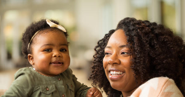 Mother Looking At Young Child Looking At Camera