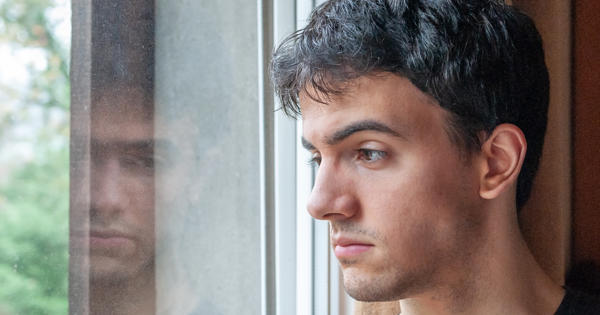 Younger Male Staring Out Of Window