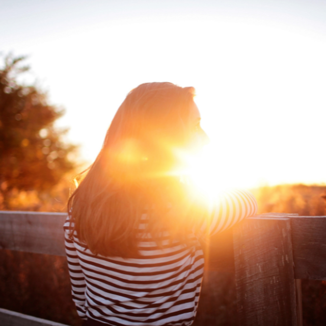 Woman Looking At Sunset